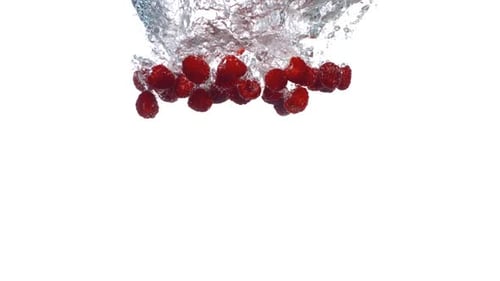 Fresh Raspberries Splash into Water on White Background