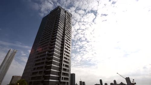 Low angle time lapse of a newly constructed apartment building with a crane hard at work