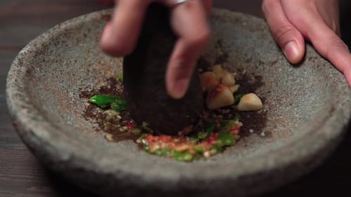 Close Up Mortar and Pestle Grinding Ingredients