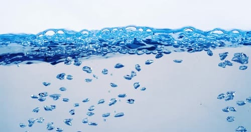 Many bubbles in water close up, abstract water wave with bubbles in slow motion