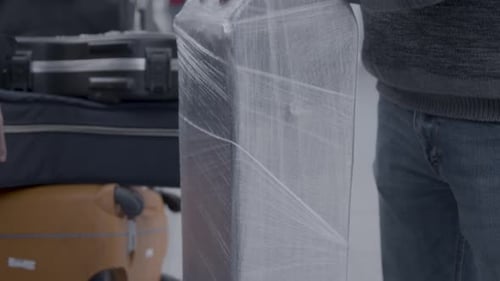 Close up on guitar case and luggage of travelling musician at airport