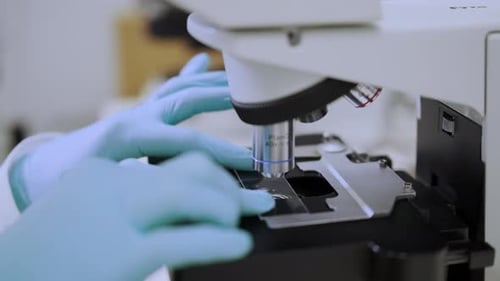 Close Up View of Microscope Objective Lenses Focusing on a Sample