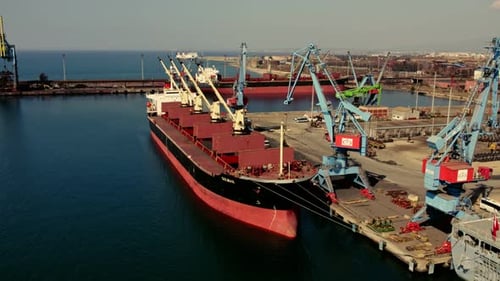 Cargo Ship Docked at Busy Industrial Port