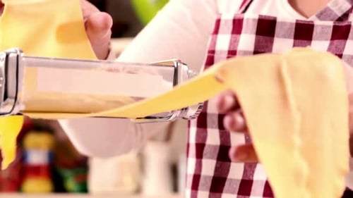Woman Making Pasta with a Pasta Machine