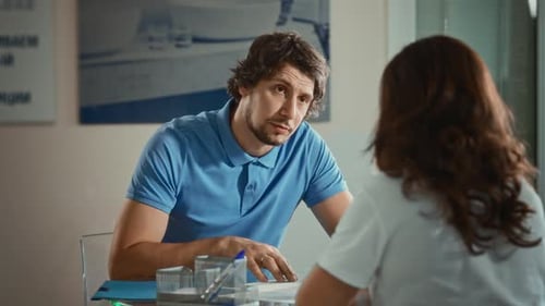 Man Reviews Documents in Bright Office Setting