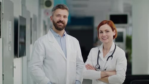 A Portrait of Man and Woman Doctor Standing in Hospital