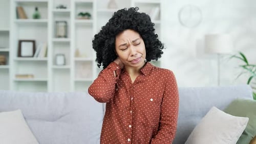 Woman Massaging Neck Due to Muscle Pain