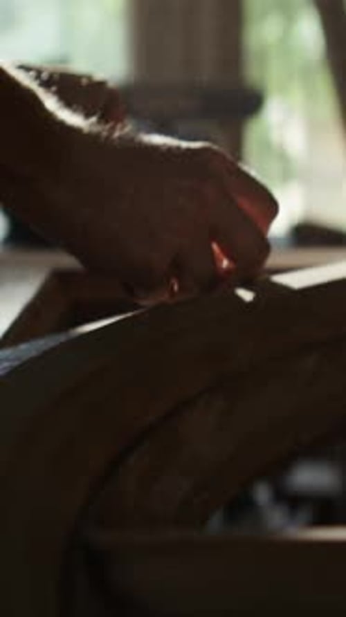 Master Blows Out Dust and Applies Paste on Door Trenches in Shop