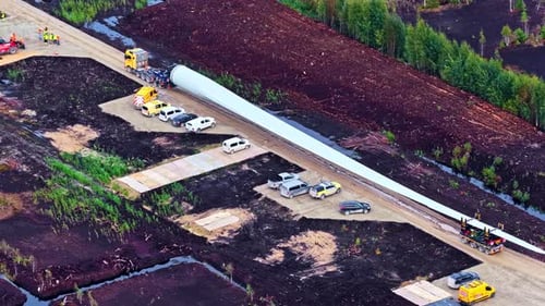 Aerial View of Wind Turbine Blade Transport on Countryside Roadway