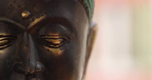 Slow pan on a Buddha statue from close up. Spirituality, meditation and third eye opening concept. 4