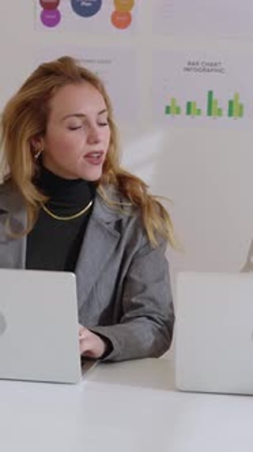 Two Professional Female Colleagues Working Together with Laptop in the Office