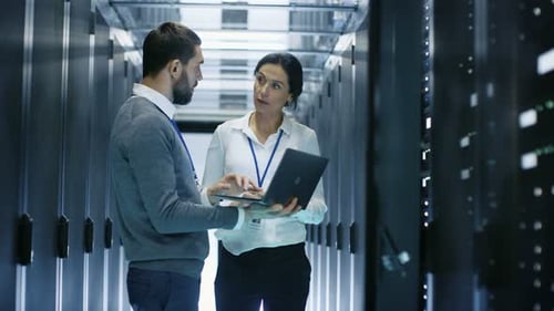 Man and Woman Working in a Modern Server Room