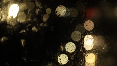 Abstract Footage of Rain on Window with Bokeh Lights