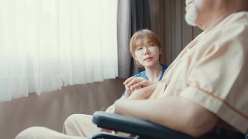 nurse lady support assist positive old guy patient sit on wheelchair at home or hospital.