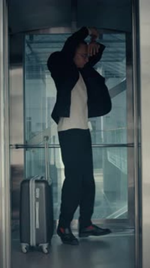 Dancing Man with Suitcase Making Solo Performance in Elevator