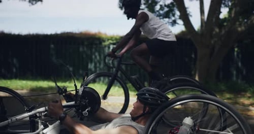 Adults Riding Bicycles on Paved Suburban Road