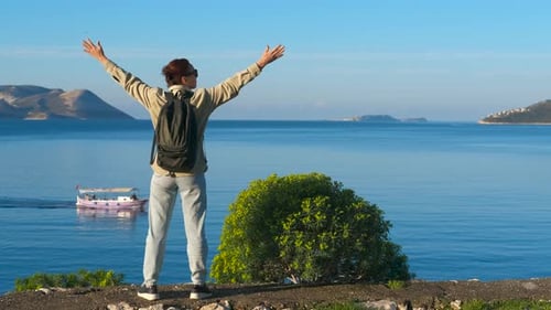 Enjoying Freedom with Open Arms By the Sea