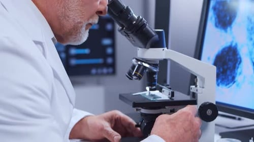 Senior Scientist Using Microscope in Modern Lab