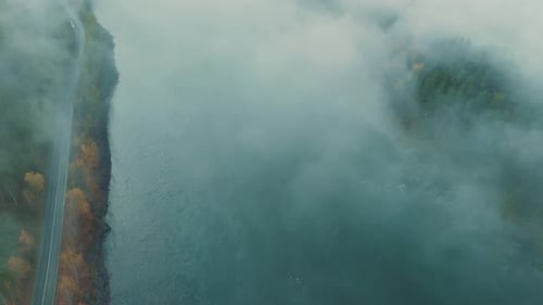 Morning Fog Envelops Tranquil River Landscape During Autumn Sunrise