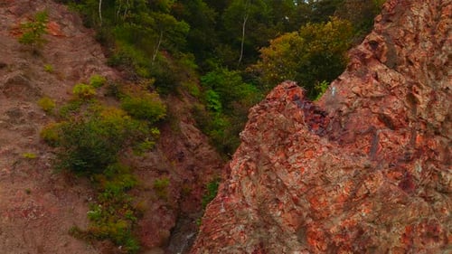 Top view of rocky ridge with forest gorge. CLip. Amazing nature with rocky slopes of green gorge.