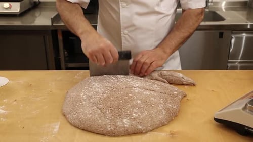 a chef makes bread in a bakery