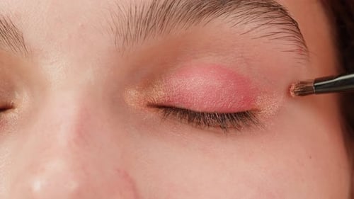 Applying Pink Eyeshadow with a Brush Close Up