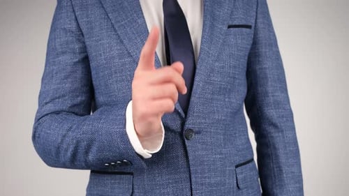 Man in Blue Jacket Points Index Finger