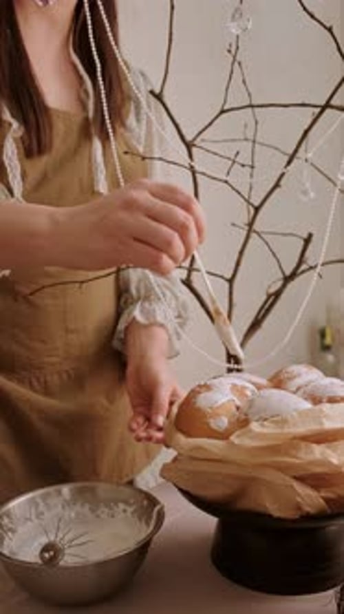 Woman Icing Cream Puffs at Home, Food Preparation
