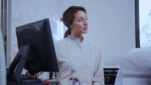 Healthcare Professionals Engaging with Technology Within the Modern Clinic Environment