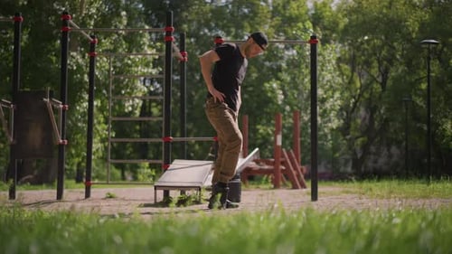 Man Stretching Leg at Sunny Outdoor Workout Park