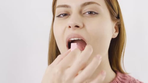 Close-up portrait of woman chewing gum.
