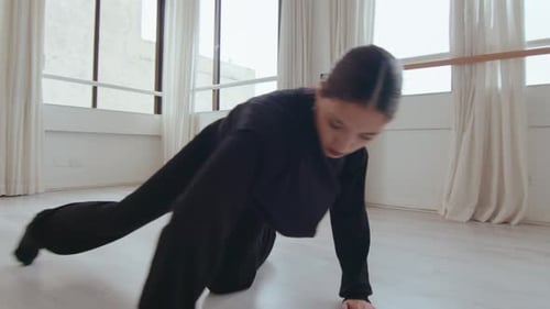 Talented Female Dancer Practicing Floor Work at the Studio