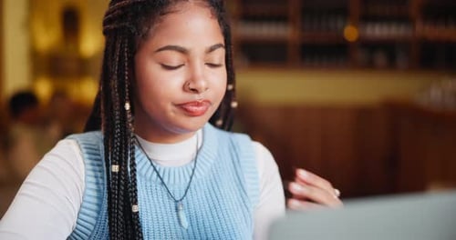 Remote work, thinking and woman with laptop in restaurant for freelance job