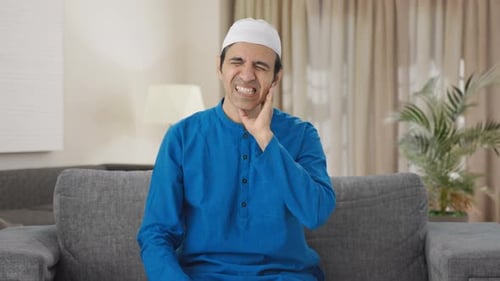 Adult Experiencing Jaw and Tooth Pain