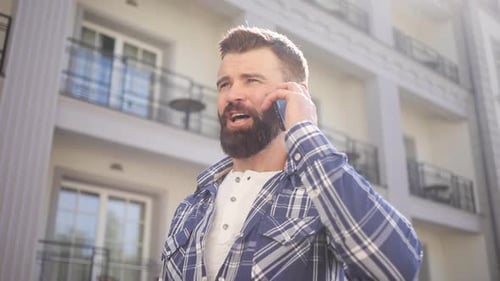 Man Using Mobile Phone Outside Building