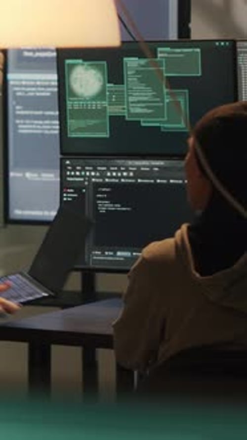 Two People Working with Computer Code Late at Night