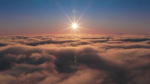 Aerial View of Golden Sunrise Above the Clouds