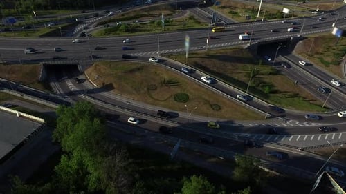 Car Driving On Roundabout Road At Highway In Summer City. Aerial View Car Traffic On Urban Highwa...