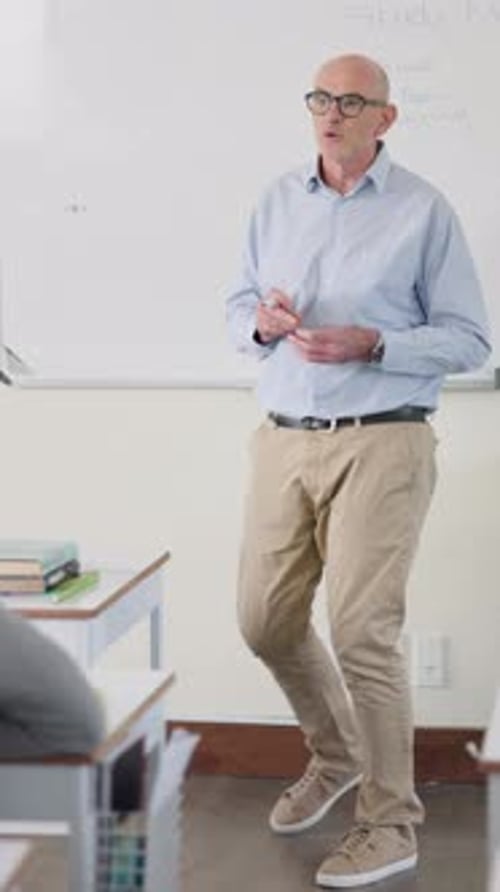 Male Teacher Giving a Lesson in Classroom