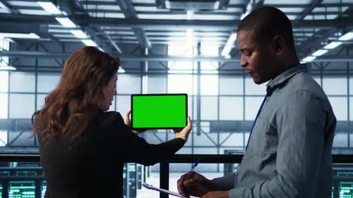 Data Center Colleagues Using Green Screen Chroma Key Device to Monitor Facility