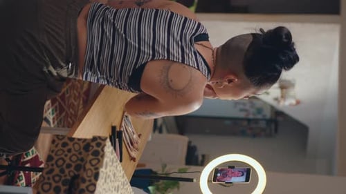 Chica maquillándose frente a la cámara y grabando un vídeo en las redes sociales