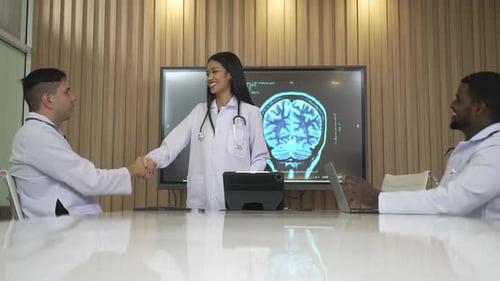 Medical Team Discussing Brain Scan in Office