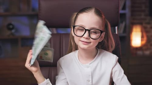 Girl Playing With Money in an Office Setting