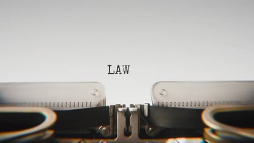 Old mechanical typewriter typing Law in a close-up view.