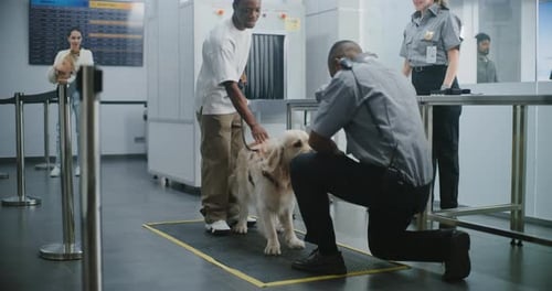 Airport Security Officer Inspects Dog with Handler