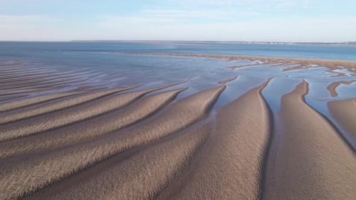 Aerial View of Rippled Sand Beach at Low Tide