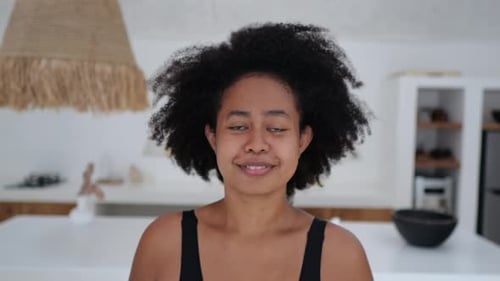 Young Adult Woman Smiling in Her Home