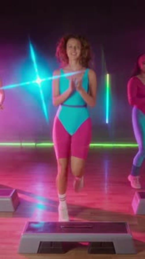 Energetic Women Doing Step Aerobics in a Fitness Studio