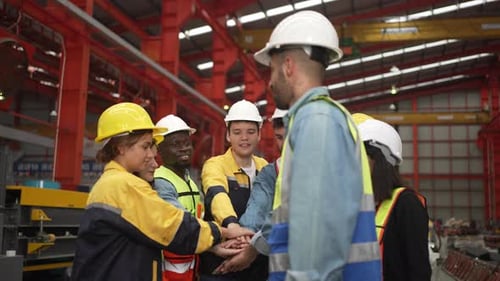 Blue collar worker work at metal sheet factory.