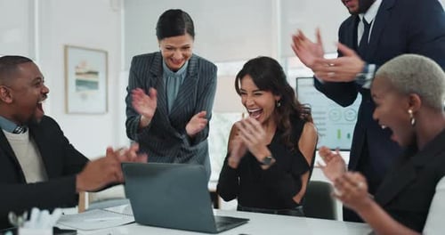 Excited Business Team Celebrates Success at Office